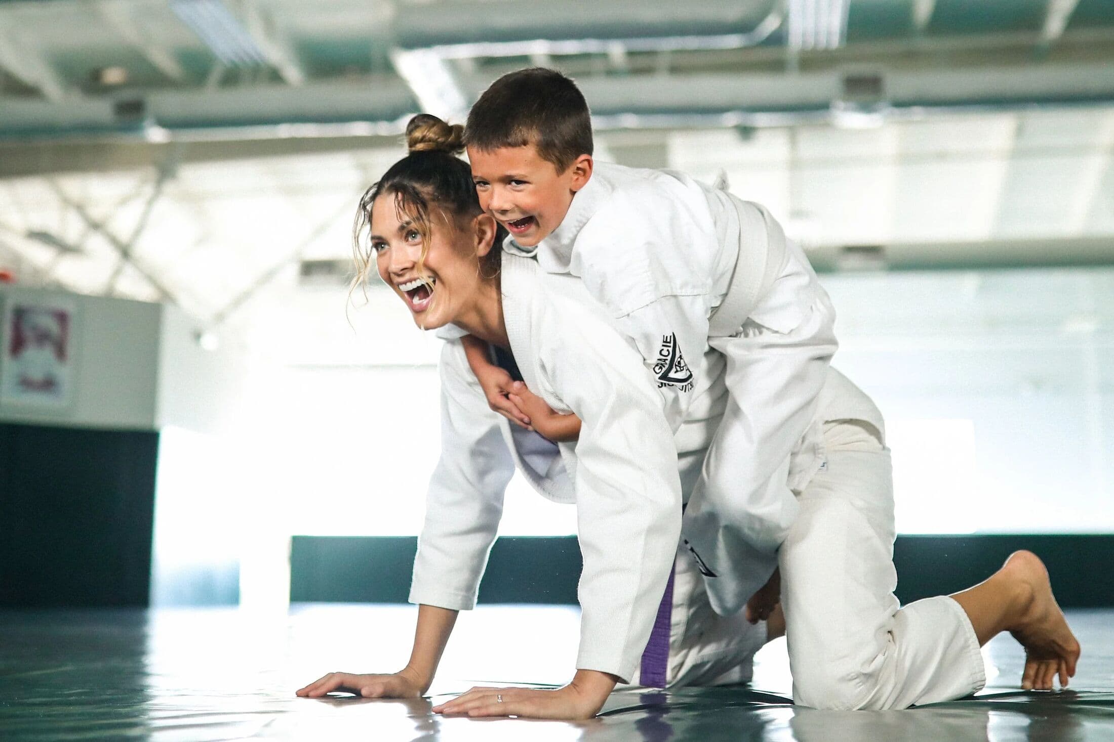 Two kids laughing on the mat